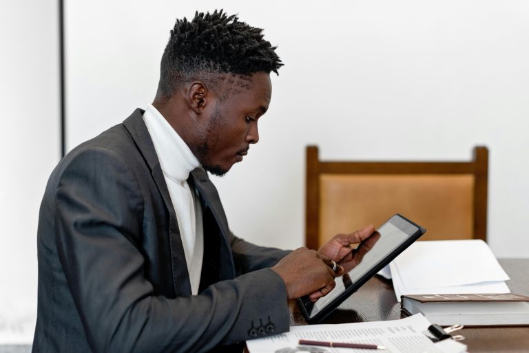 A Remote Corporate Paralegal Working On A Tablet