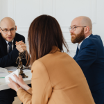 Lawyer Talking To Clients Backed By Litigation Support
