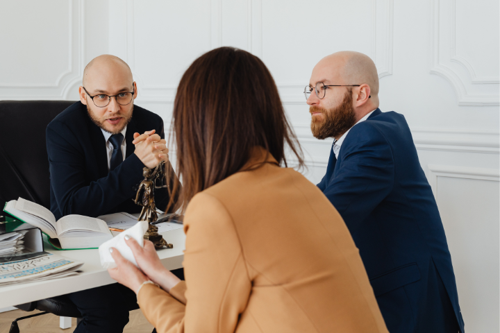 Lawyer Talking To Clients Backed By Litigation Support